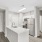 Renovated kitchen with white cabinetry and stainless steel appliances